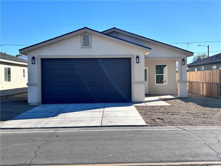 Ranch-style house with stucco siding, driveway, and a garage