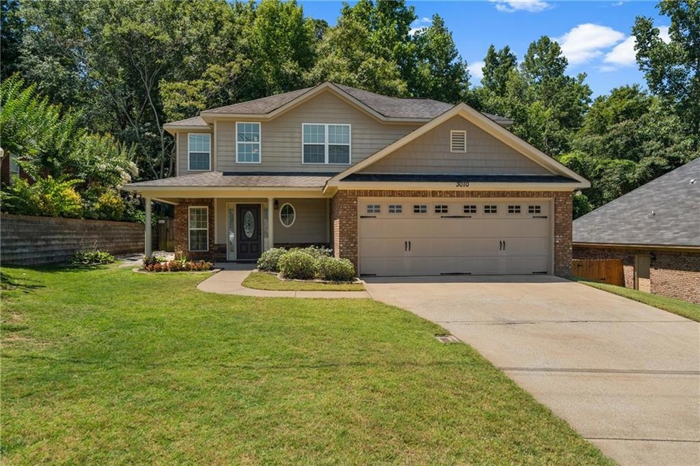 Craftsman-style home with a porch, a garage, and a