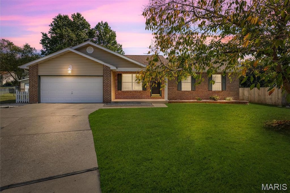Ranch-style house with brick siding, concrete driveway, and a garage