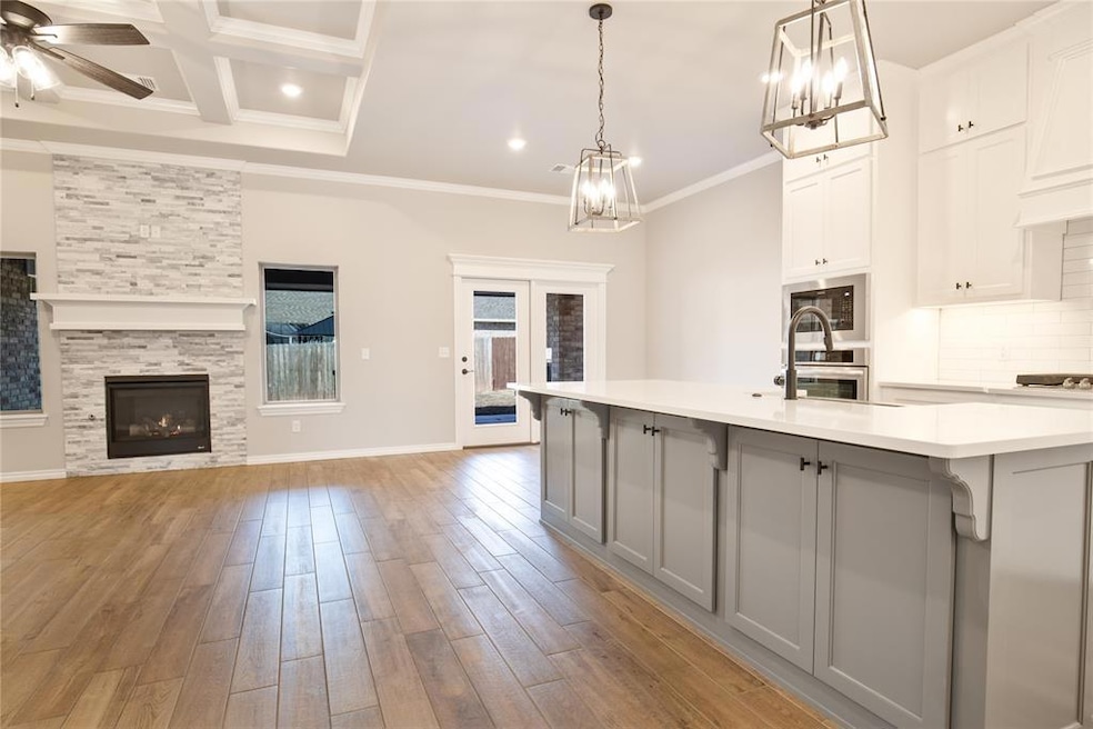 Kitchen with ceiling fan with notable chandelier, 