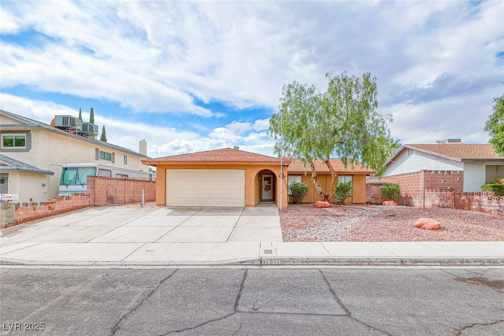 Ranch-style house with an attached garage, fence,