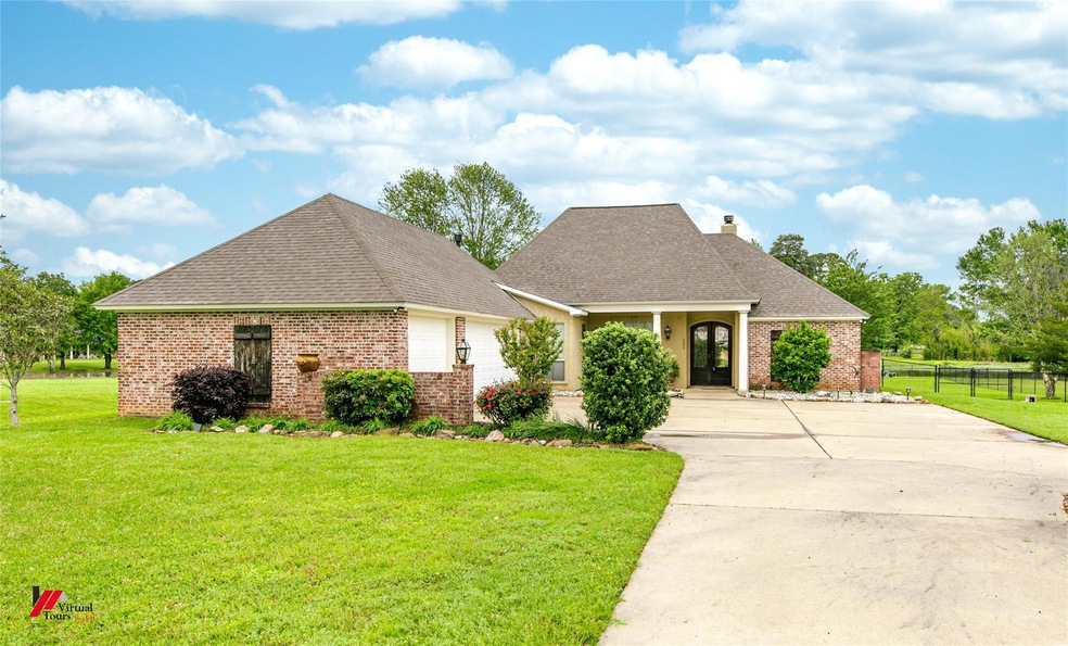 View of front of house featuring a garage and a front yard