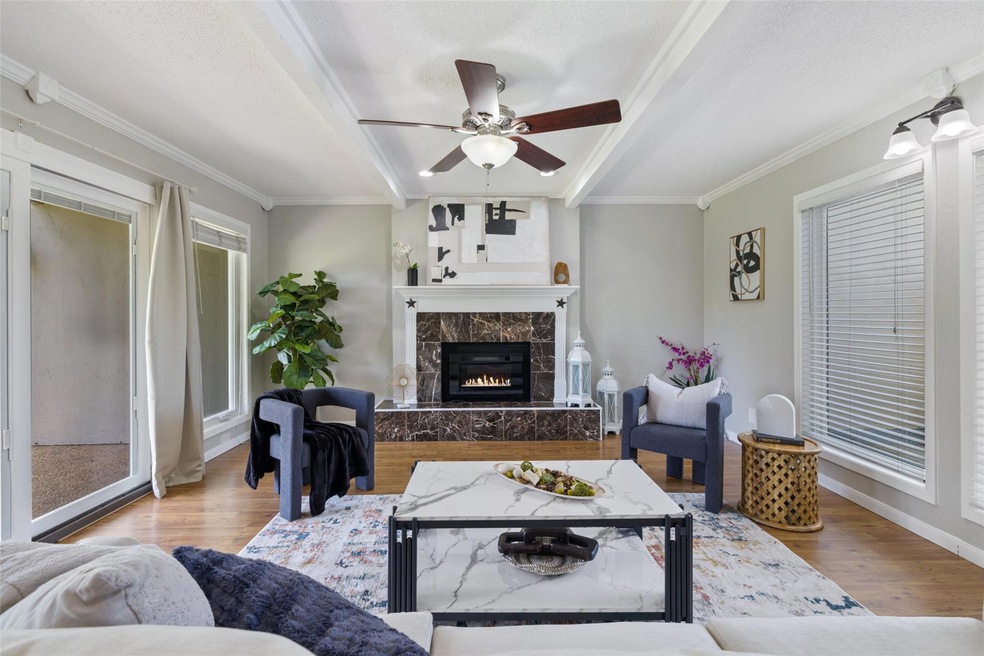 Living area with wood finished floors, crown mold