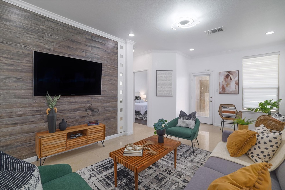 Tiled living room with recessed lighting, baseboa