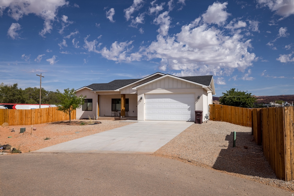 Single story home with driveway, a garage, a shingled roof, and covered porch