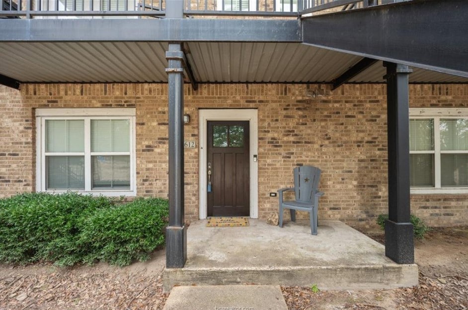 Entrance to property with brick siding