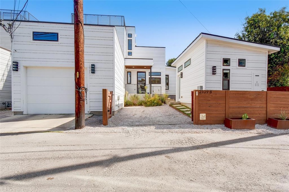 Front of property with garage & gated parking spac