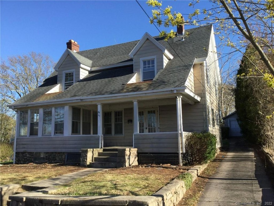 Front exterior, paved drive to 1-car garage
