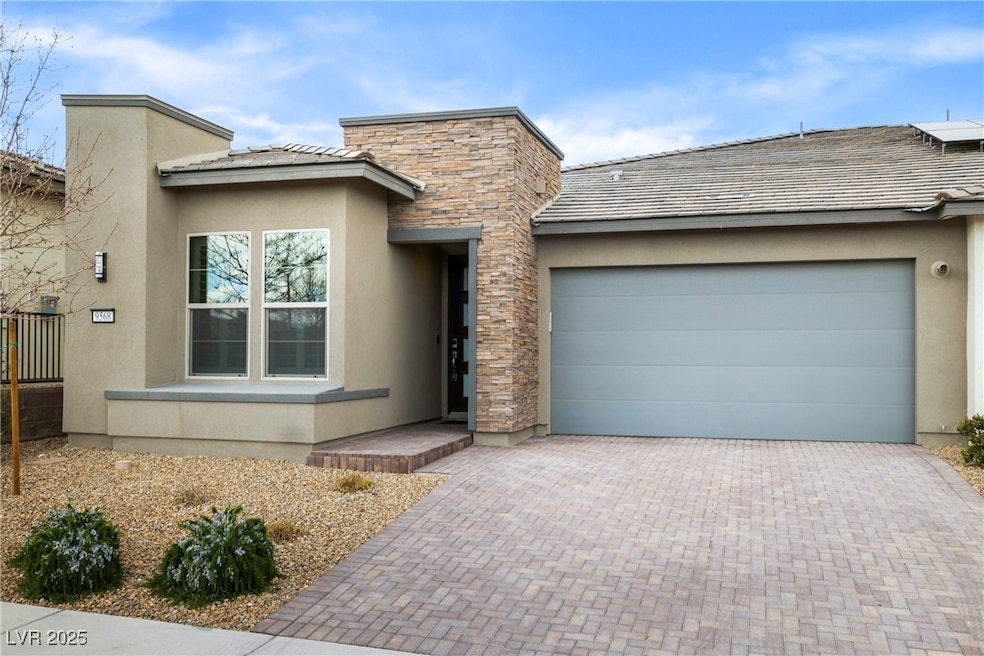 View of front of home with decorative driveway, st