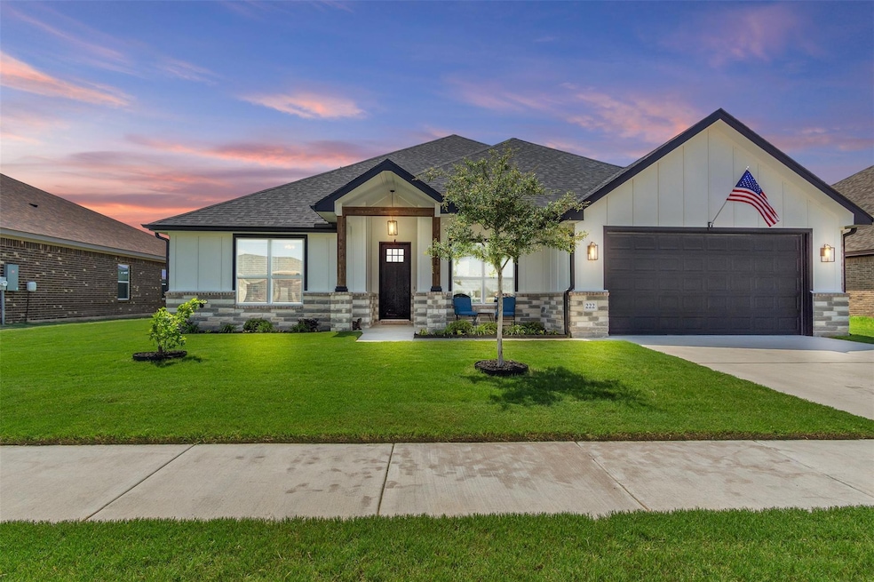 View of front of property featuring a garage, boa