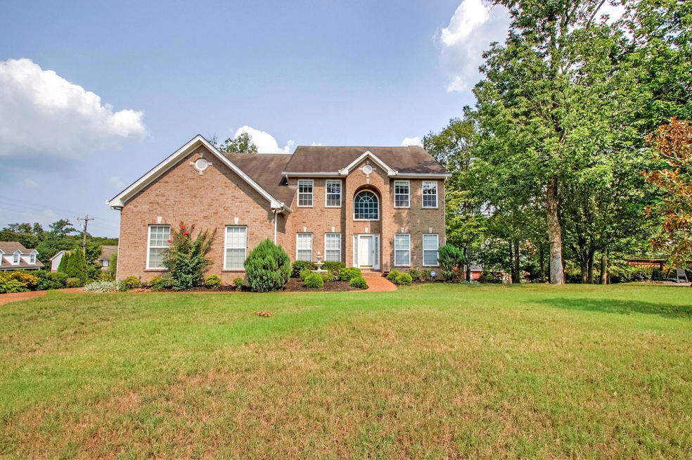 Beautiful brick home on large lot with driveway on left that is a 