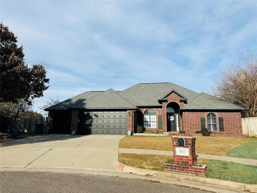 View of front of home featuring a garage and a front lawn