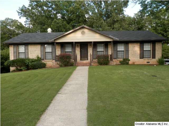 Front view with large front porch and pretty yard