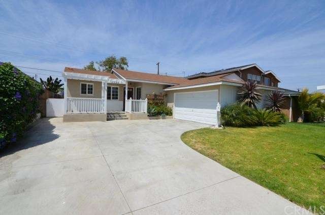 Large driveway and nice landscaped lawn.