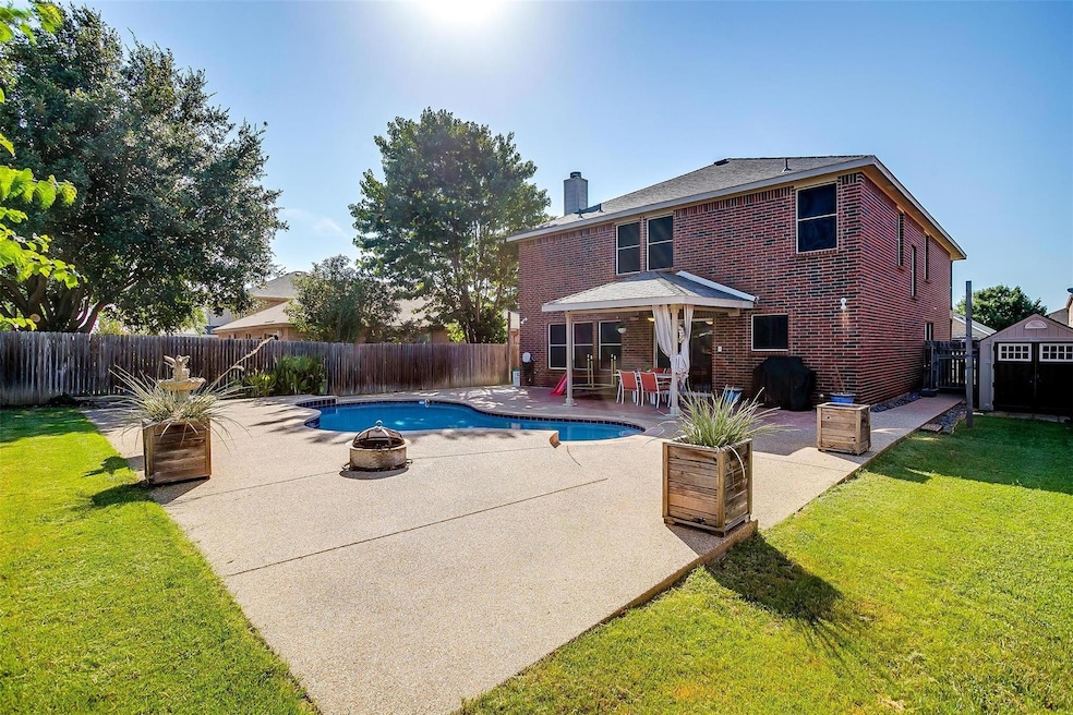 View of pool, a storage unit, a lawn, a patio area