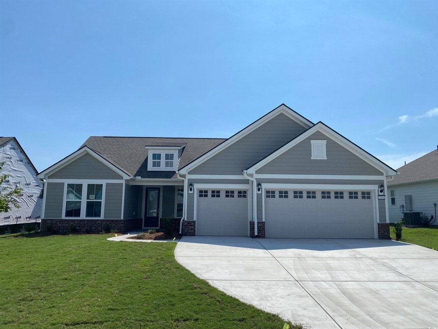 Craftsman inspired home with a front lawn and a ga