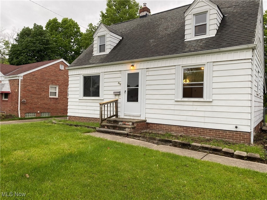 Cape cod-style house with a front yard, roof with shingles, and a chimney