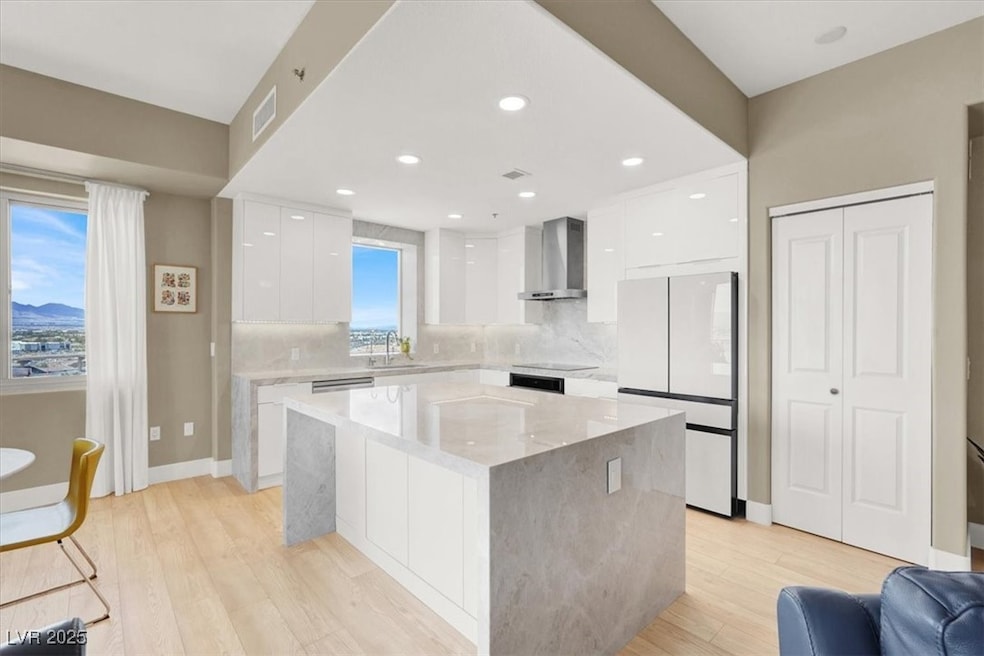 Kitchen featuring white cabinets, visible vents, f