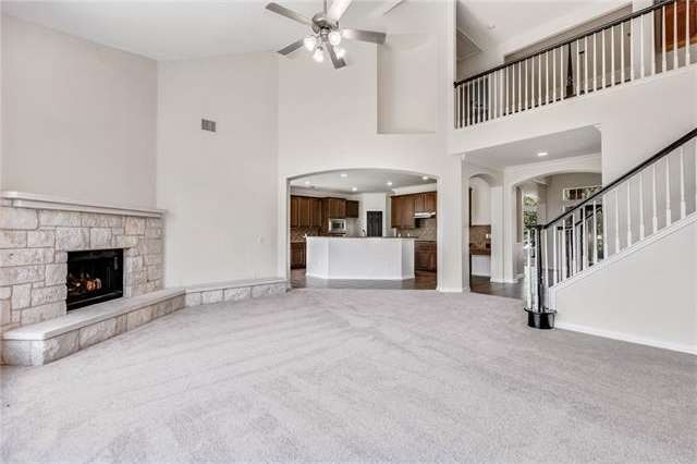 Livingroom facing kitchen.  Fireplace and high cei