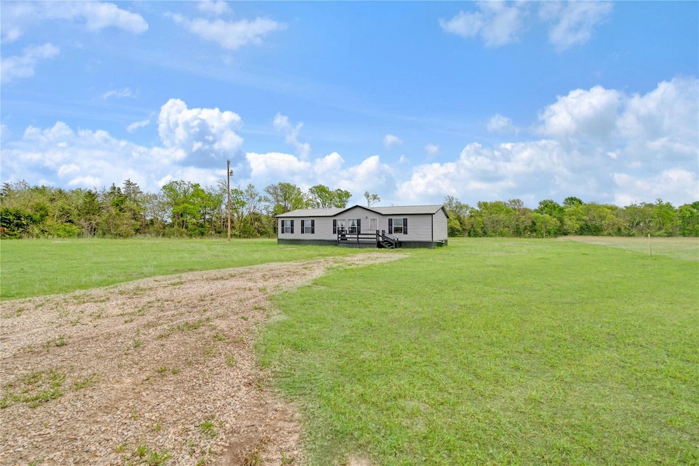 View of front of home featuring a front yard and a rural view
