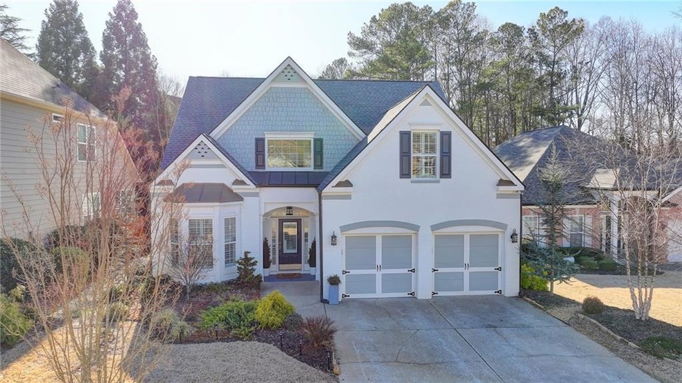 View of front of home with concrete driveway, a garage, and a standing seam roof