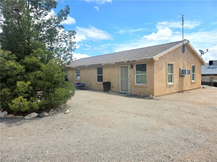 Back of property featuring stucco siding and roof