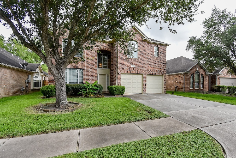 This two-story brick home features a spacious driv