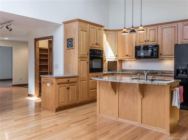 newer kitchen with granite countertops and open fl