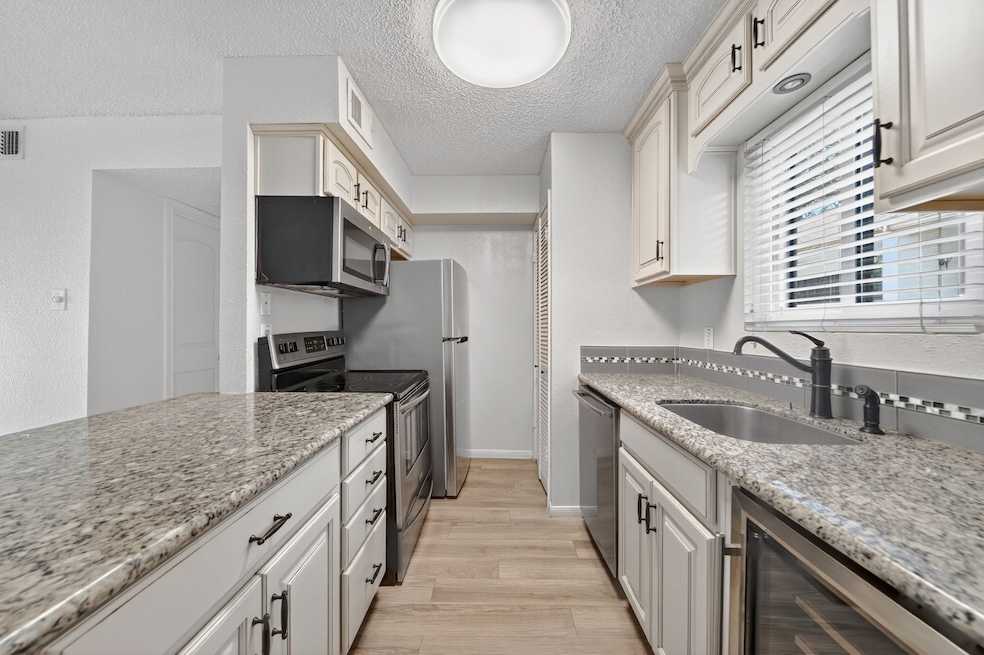 Renovated kitchen with stylish cabinetry, microwav