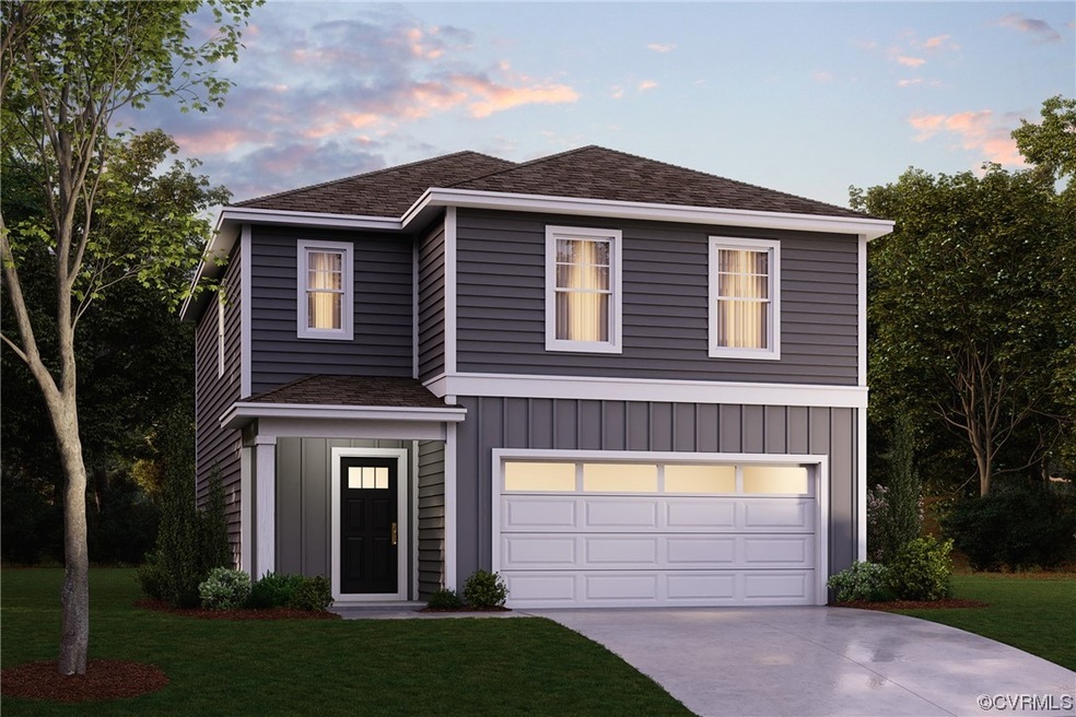 View of front of property with a garage and a yard