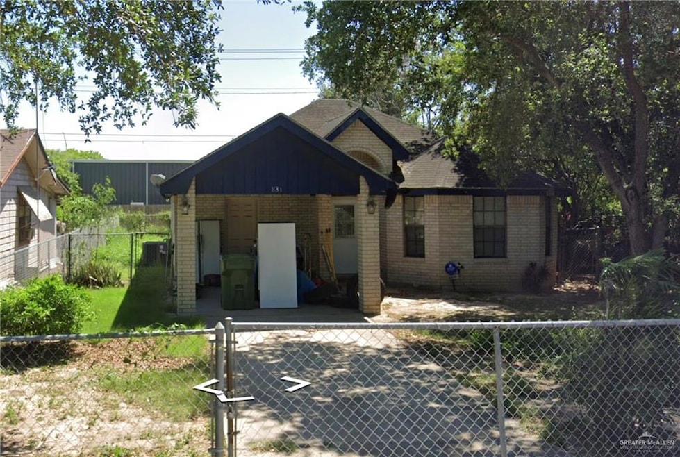 View of front of house featuring brick siding and board and batten siding