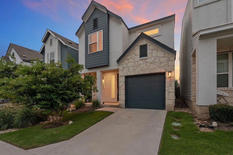View of front of property with stone siding, driv