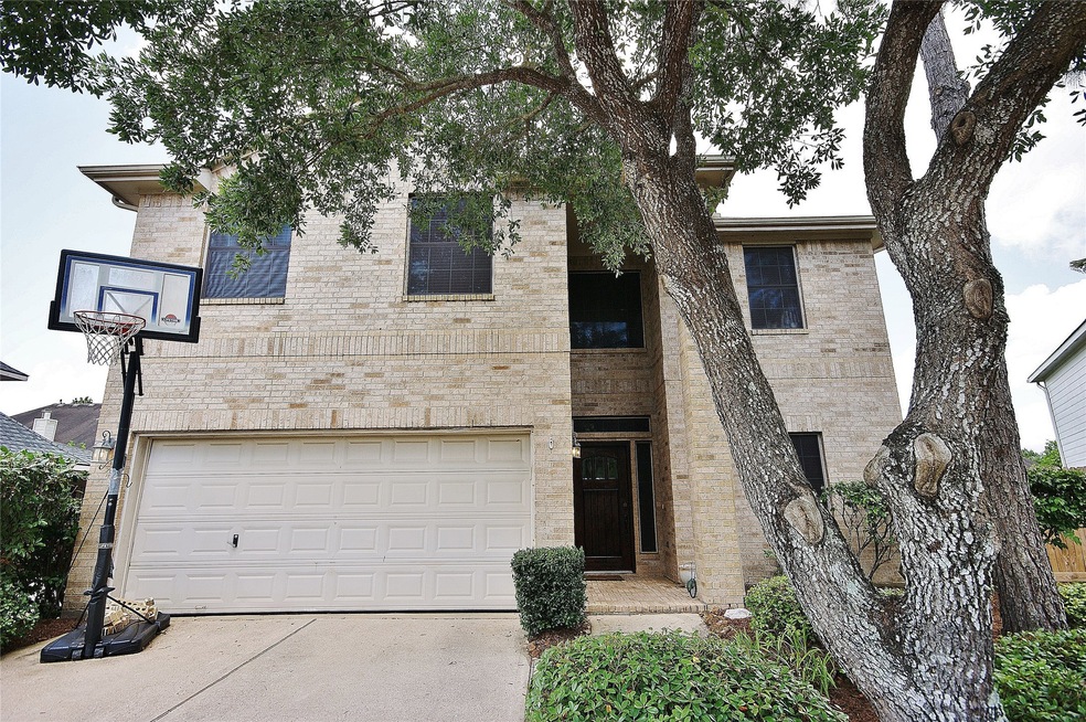 FRONT OF THIS 4/3.5/2 HOME WITH A POOL ON A CUL-DE-SAC LOT