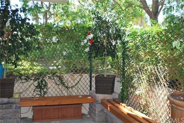 private patio with lush green wall