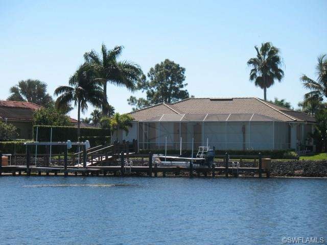 Rear of home from the water featuring new 80-foot 