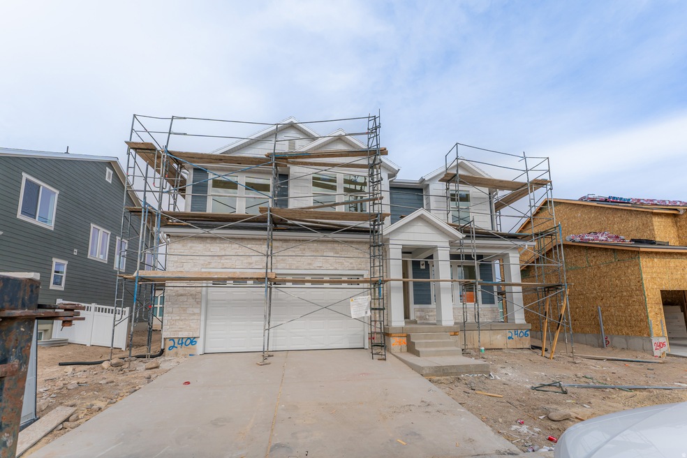 Property under construction with driveway and an attached garage