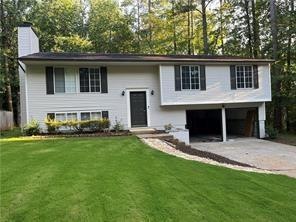 Raised ranch featuring a front lawn