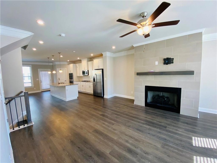 Unfurnished living room with crown molding, dark w