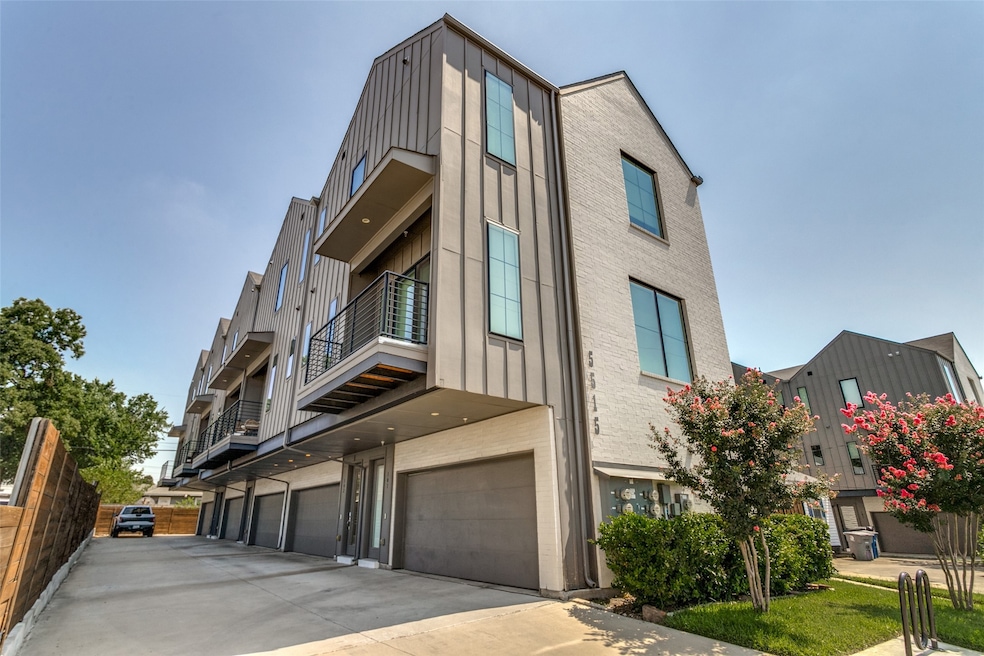 View of front of home featuring a balcony and a garage