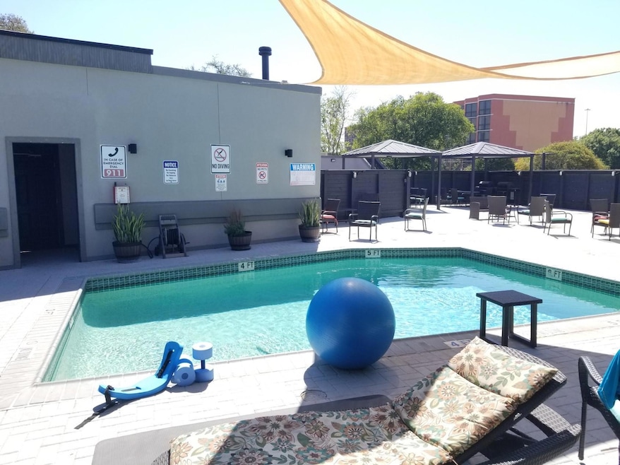 Pool with a patio and fence