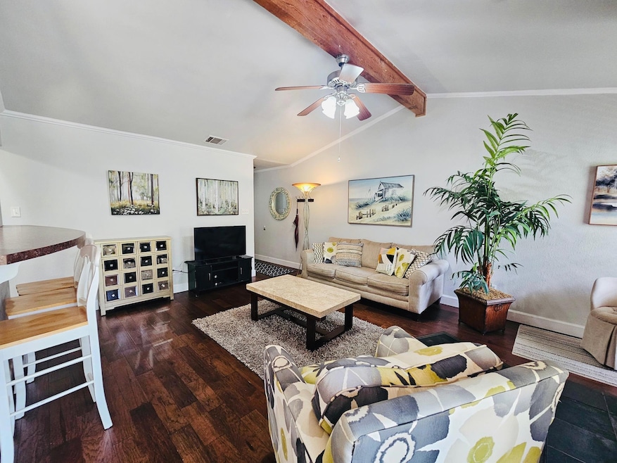 Living room featuring visible vents, lofted ceili