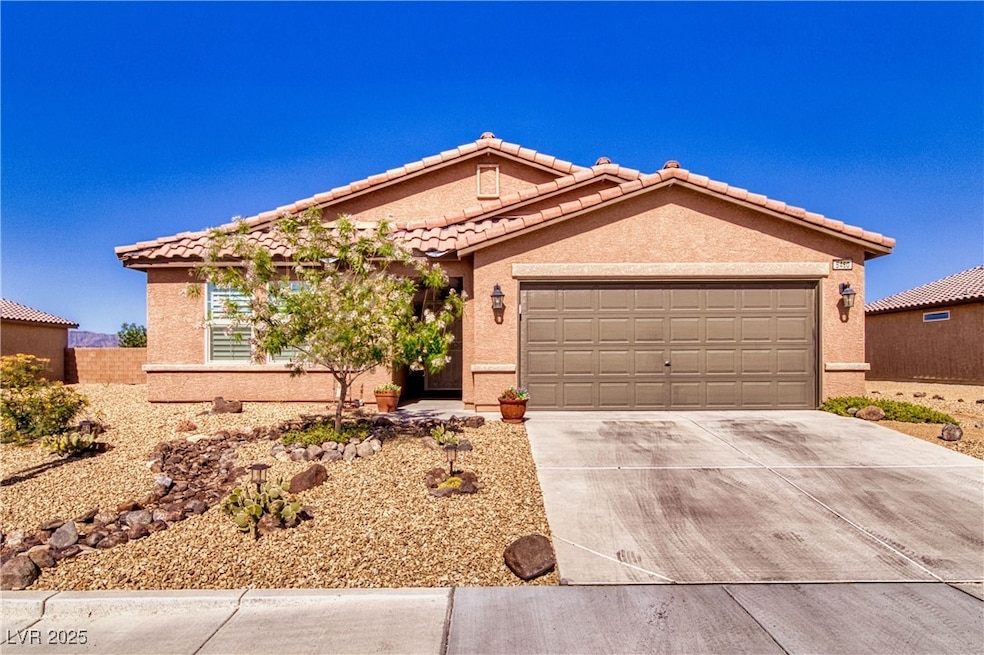 View of front of home featuring driveway, a tiled