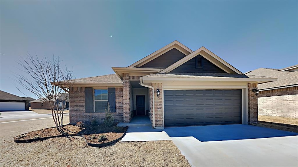 Ranch-style house featuring brick siding, a garage, and driveway