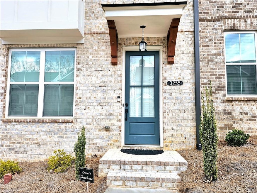 Doorway to property featuring brick siding
