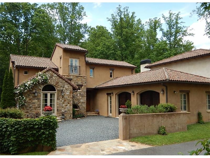 Designed by Bill Harrison, this Tuscan-style home 