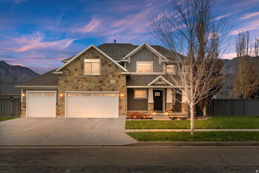 Craftsman inspired home featuring a porch, a mountain view, driveway, and board and batten siding
