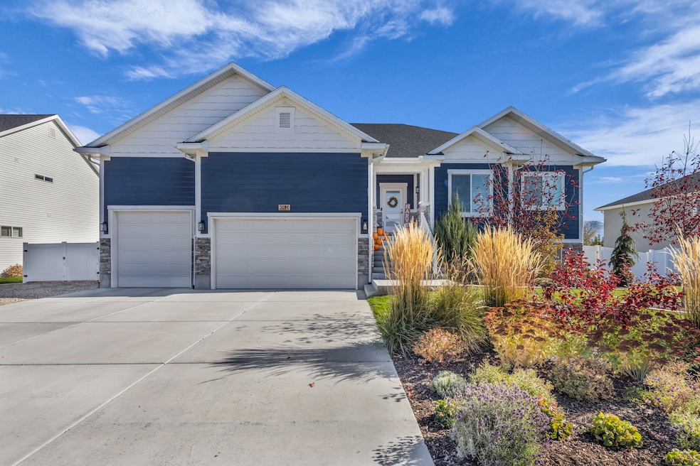 Ranch-style house featuring concrete driveway, a garage, and stone siding
