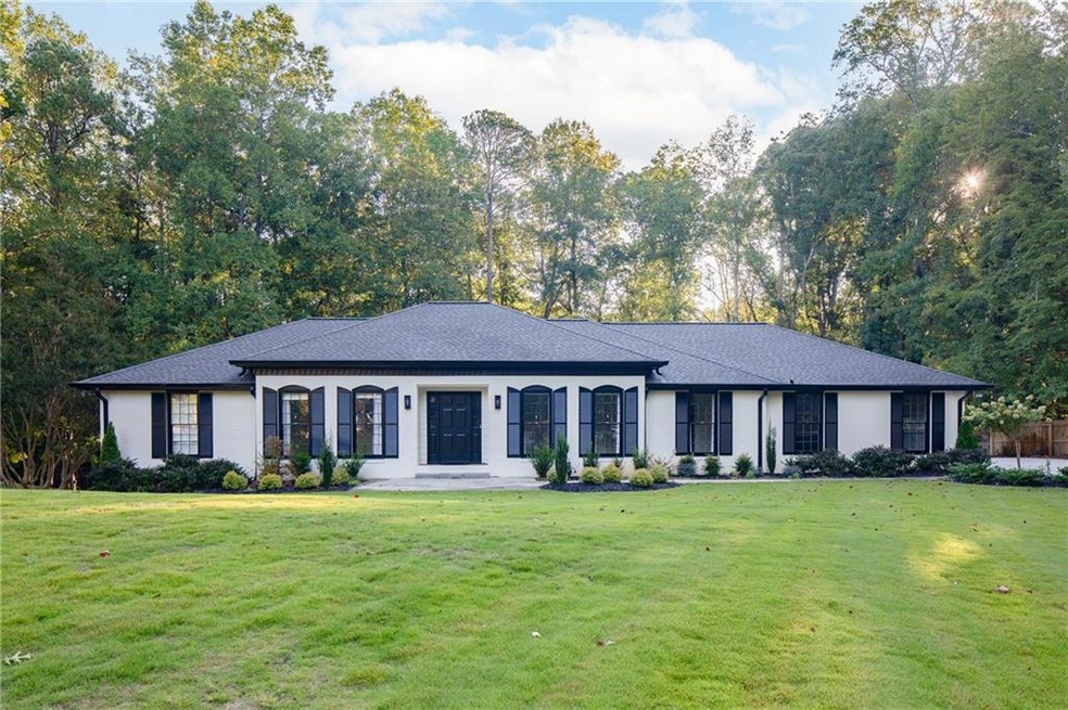 Ranch-style house featuring a front lawn