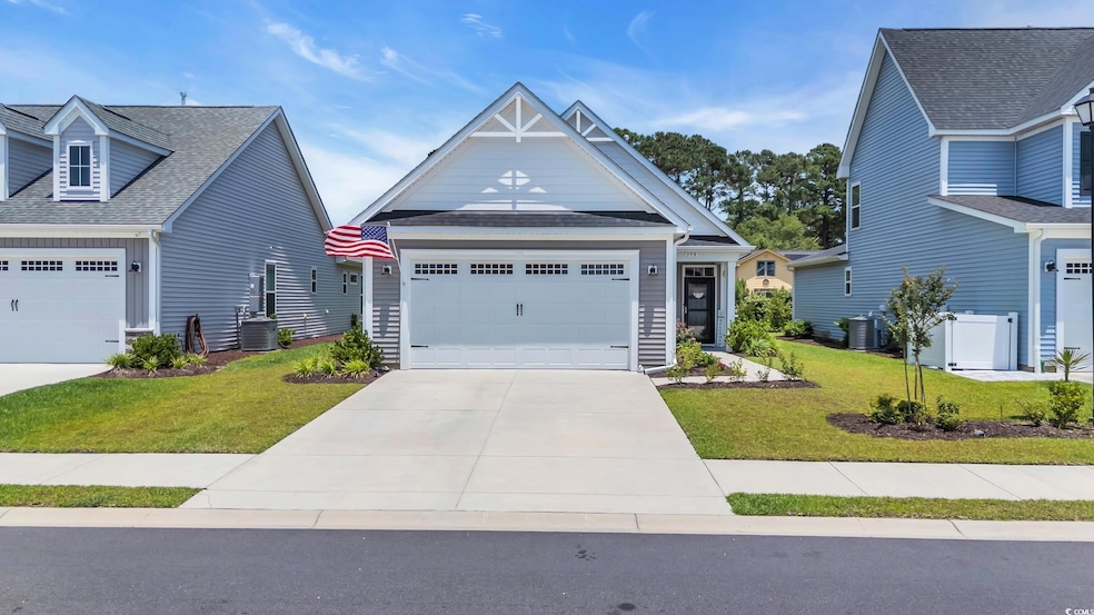 Craftsman house featuring a front lawn, driveway, central AC unit, a garage, and roof with shingles