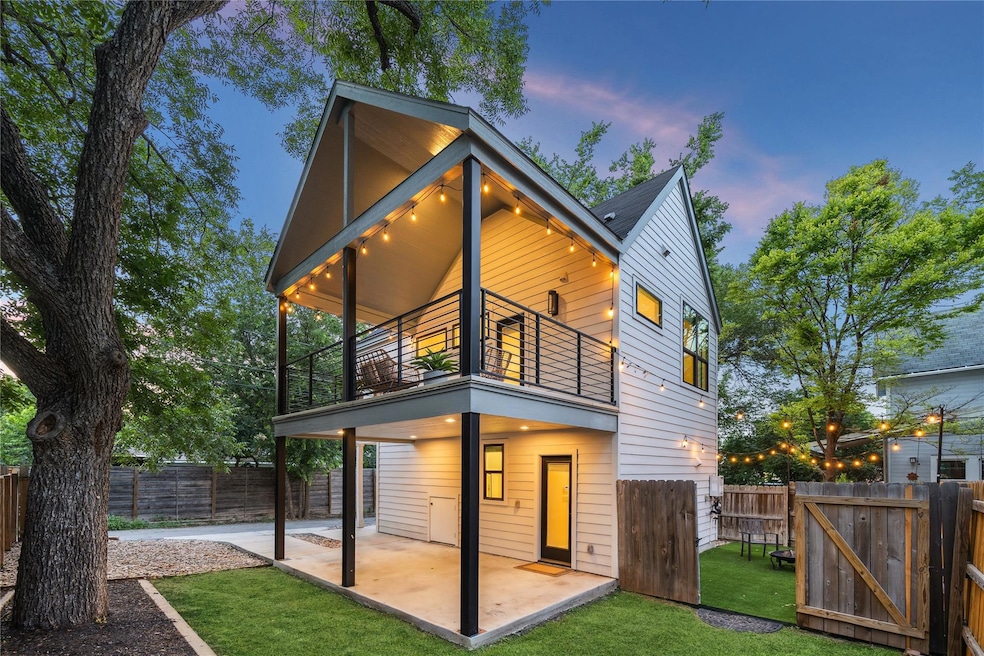 Rear view of property featuring a balcony, a pati